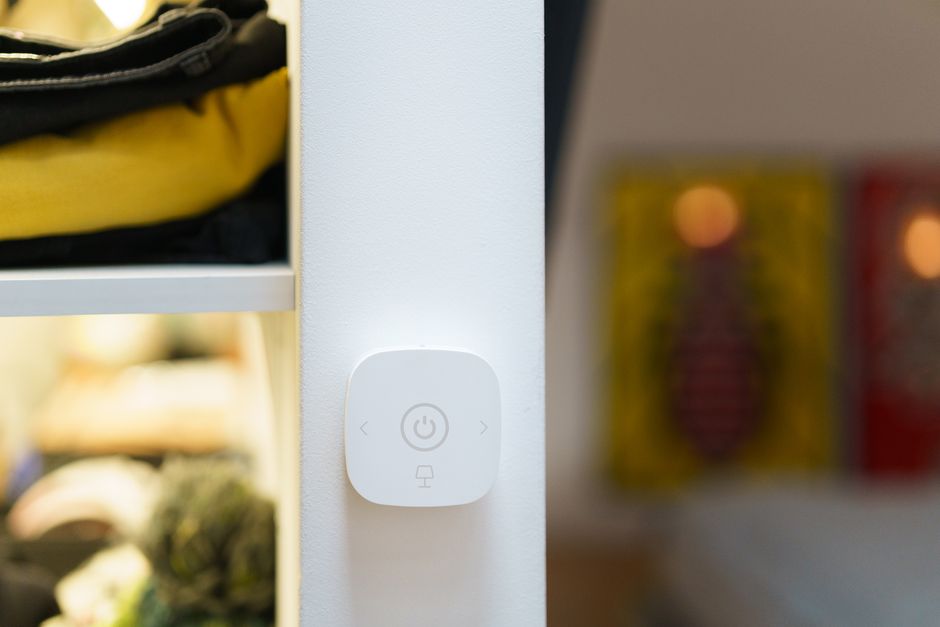Close-up of a smart home light switch in a modern room interior, showcasing contemporary technology.